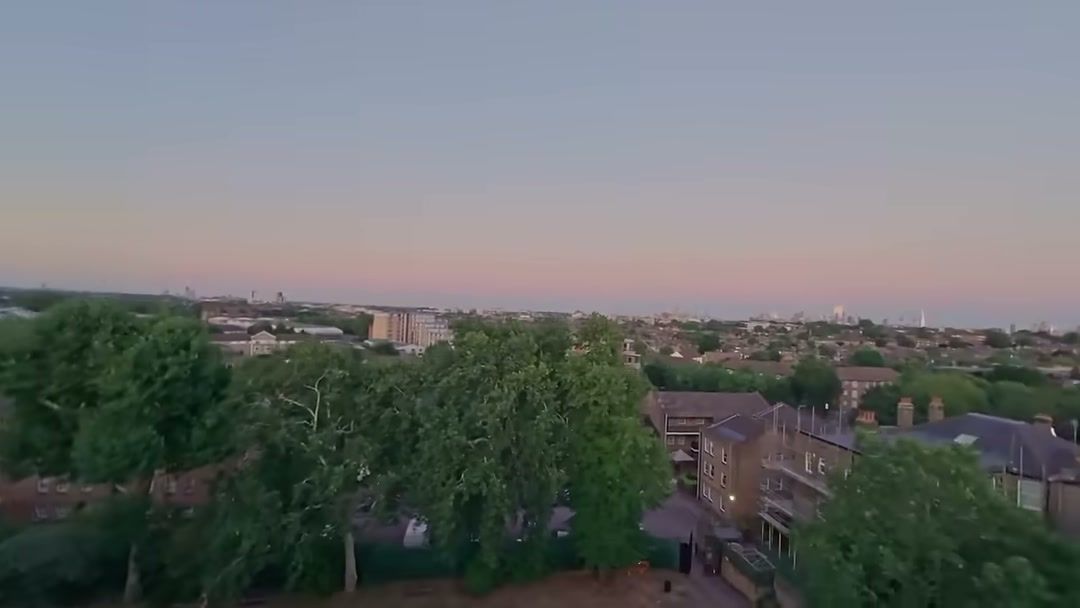 FPV view at sunset over London rooftops while flying the Avata 2 in reverse