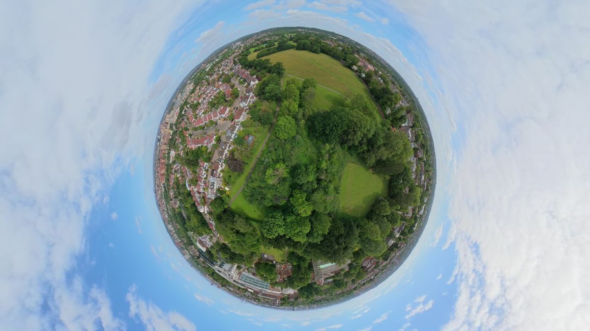 Tiny planet frame reframed from DJI Avata 360 footage over houses and parkland