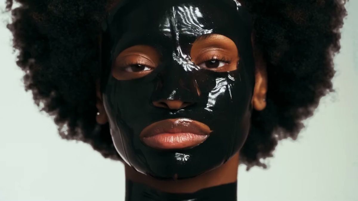 Model wearing a black 111SKIN face mask