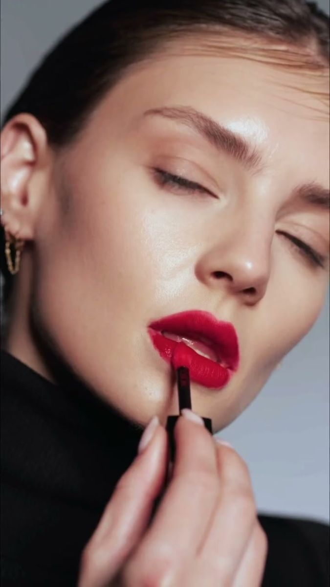 Studio beauty portrait with slicked hair, closed eyes and a red lip