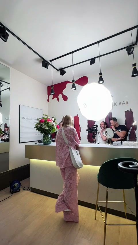 Kelly Rutherford walking onto a bar set lit by one large round light, Code8 campaign behind the scenes in London