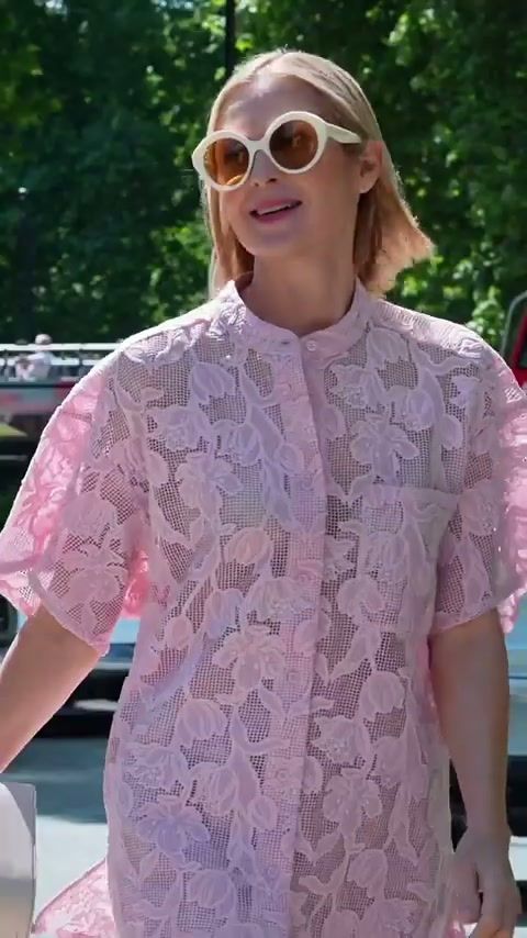 Kelly Rutherford in a pink lace shirt and white sunglasses on a London street, Code8 campaign behind the scenes