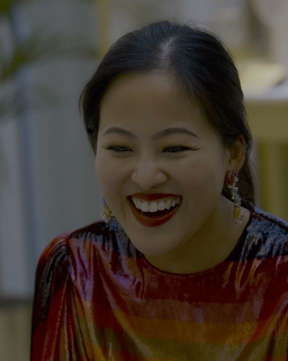 Jewellery designer Anabela Chan laughing at the Bayt Damas event in Dubai, wearing her own earrings
