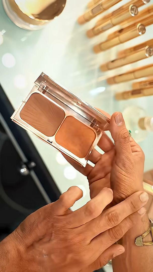 Make-up artist holding a Charlotte Tilbury palette on the Eid billboard shoot