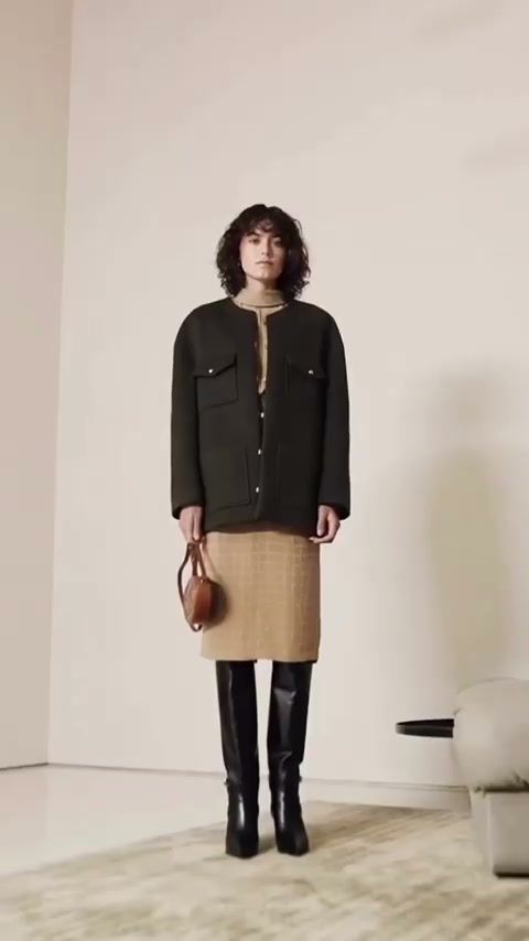 Full-length Celine look on a minimal set with a cream wall