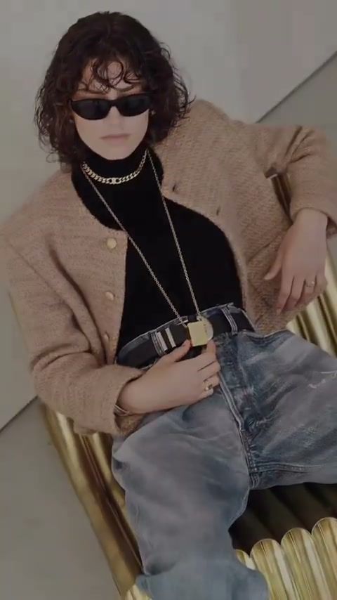 Model in Celine sunglasses lounging on a gold chair