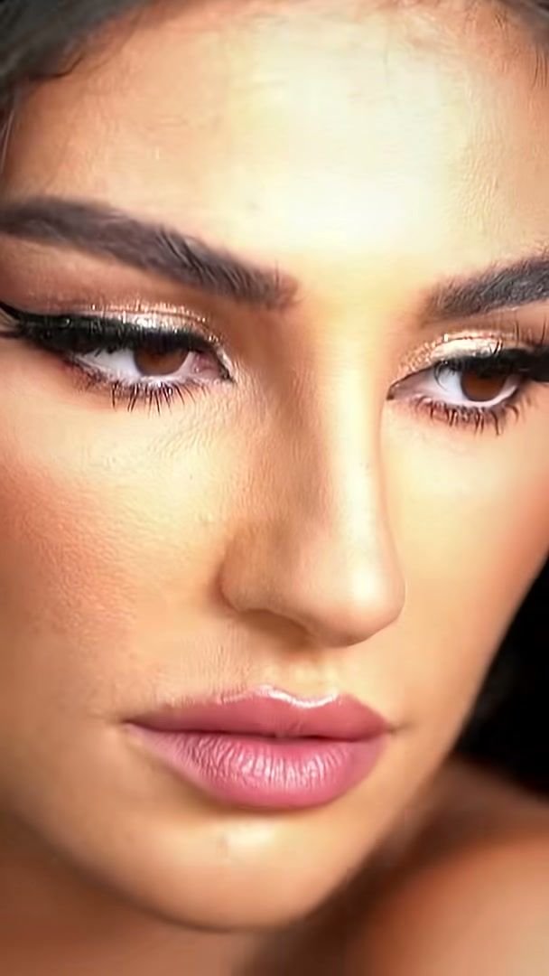 Tight beauty close-up of the model's eyes and glowing skin on the Charlotte Tilbury set