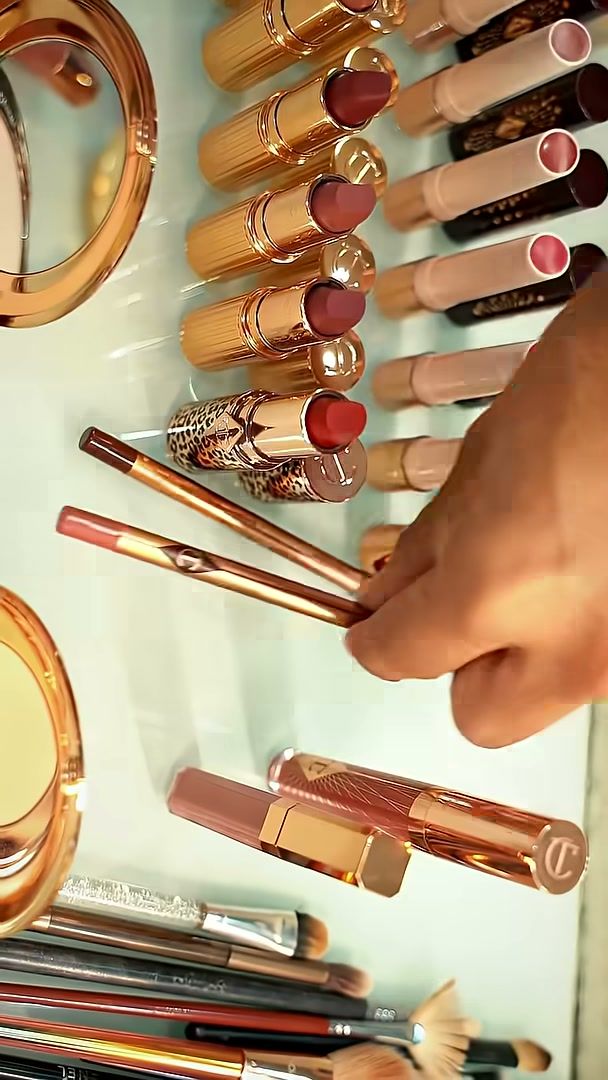 Charlotte Tilbury lipsticks and brushes laid out at the make-up station