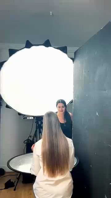 Large round softbox lighting a model in a white studio, Code8 foundation shoot behind the scenes