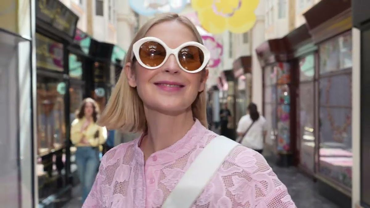 Kelly Rutherford in white sunglasses walking through a London arcade, Code8 campaign film