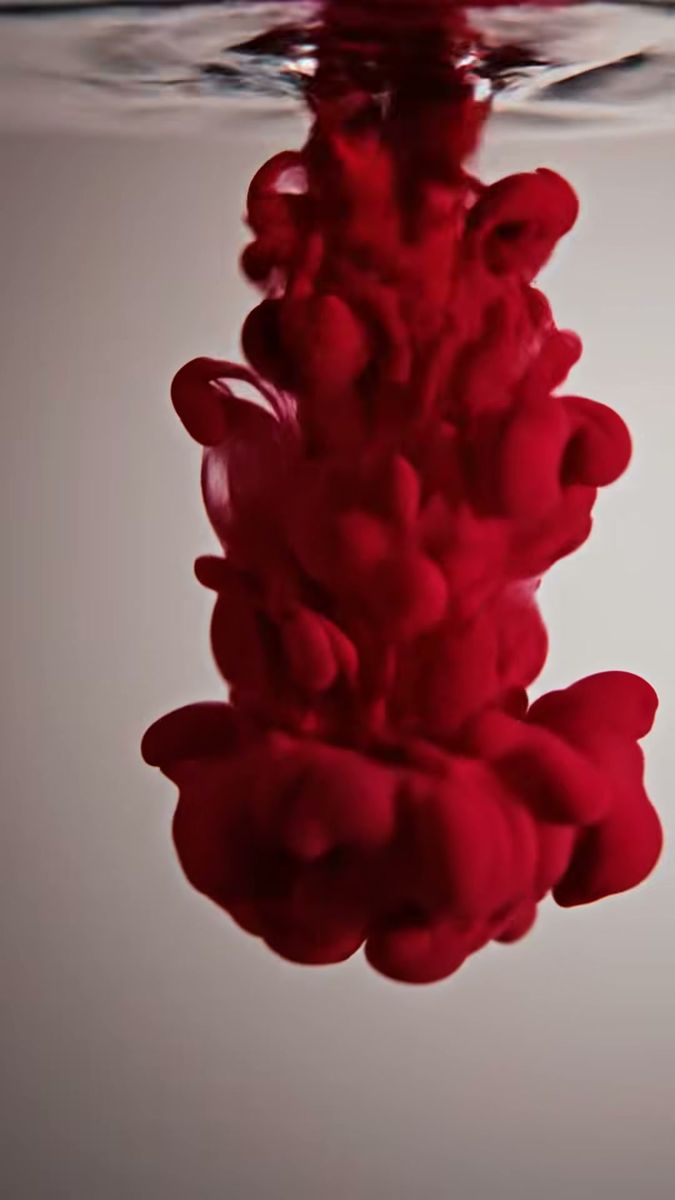 Red ink blooming in water, a product colour shot from the Waterproof film