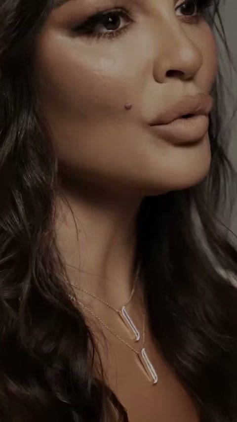 Nadine Njeim wearing an ALIF by Damas pendant on set