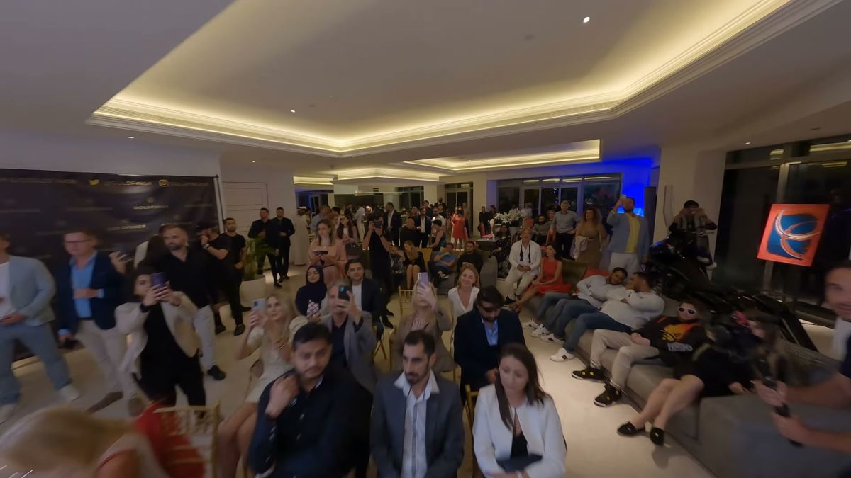 FPV drone shot flying over a packed indoor event