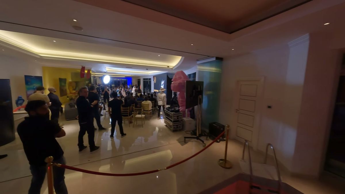 FPV drone passing a roped-off indoor pool during an event inside a Dubai tower