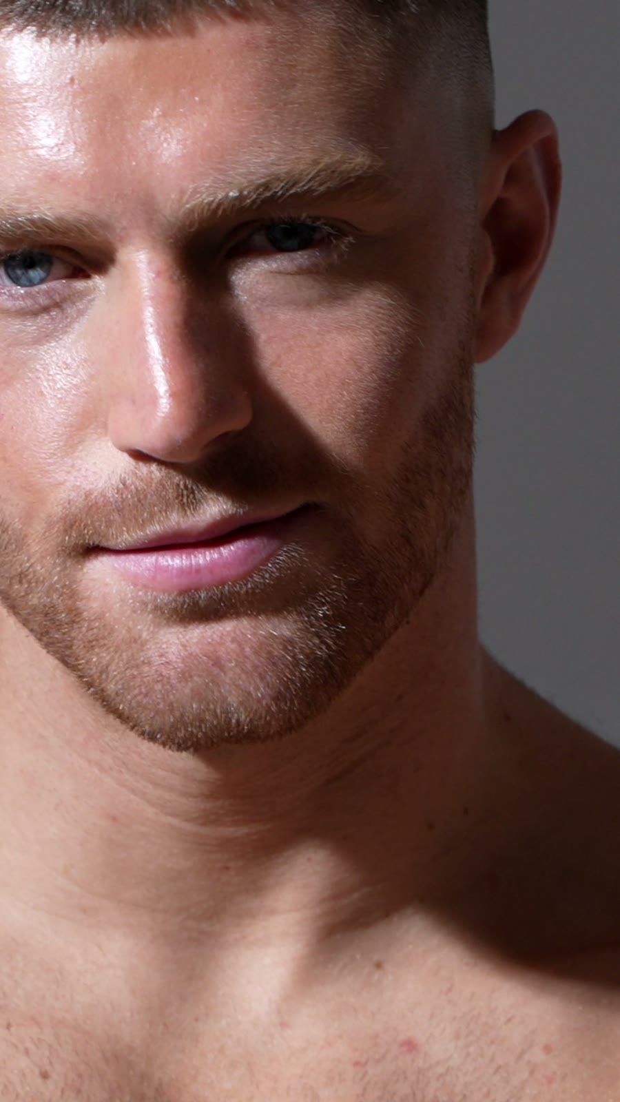 Close-up portrait of a model with blue eyes and short hair, vertical frame from a DRT film