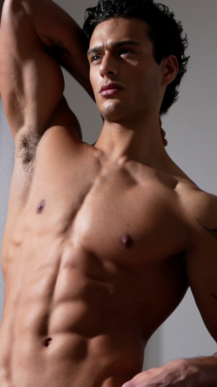 Model with an arm raised in window light, vertical frame from a DRT film