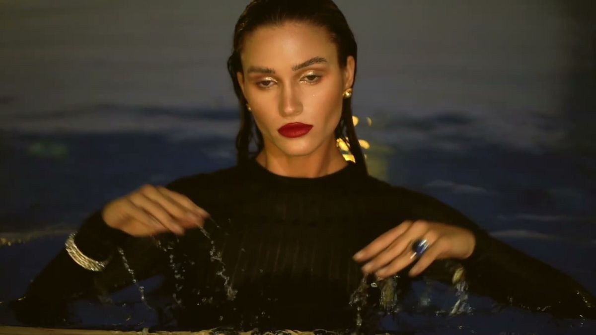 Model in a pool at night wearing jewellery, Dubai editorial