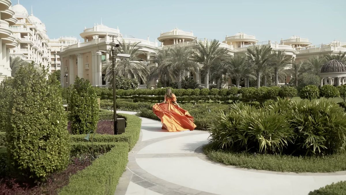 Model in a flowing gown in a Dubai palace garden, Damas Jewellery campaign