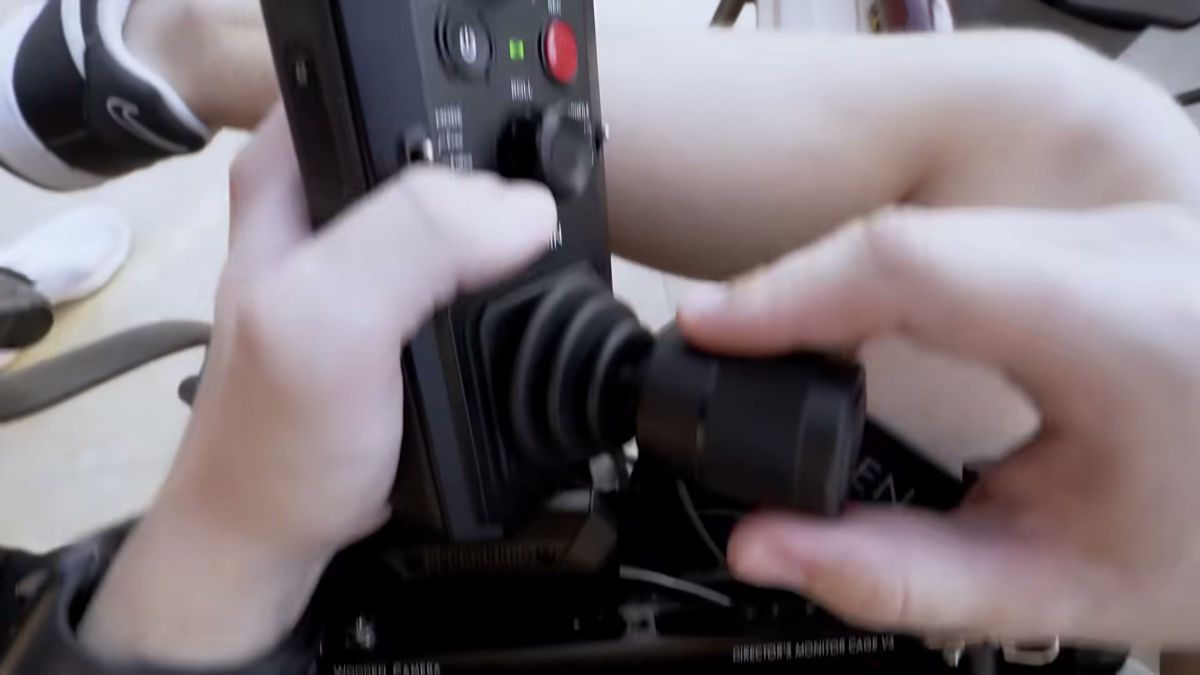 Hands on a camera controller on set during the Damas Jewellery shoot in Dubai