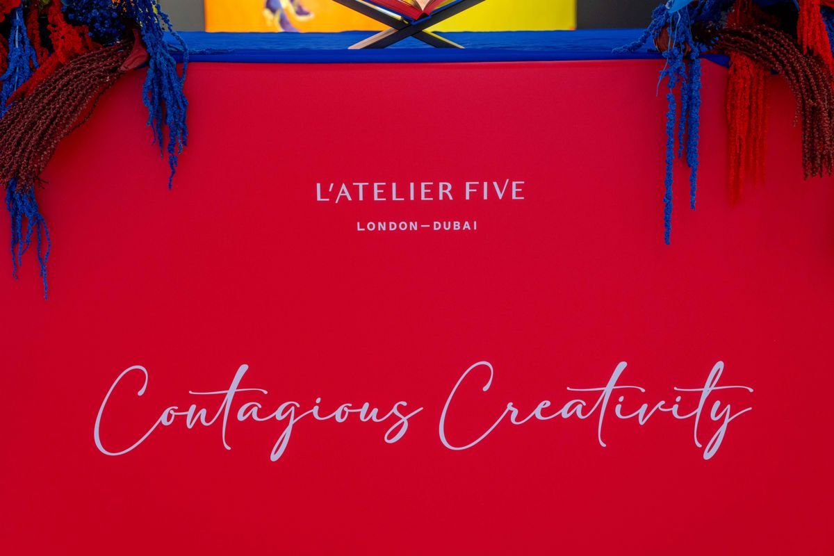 Red L'Atelier Five Contagious Creativity presentation box with blue and red floral styling