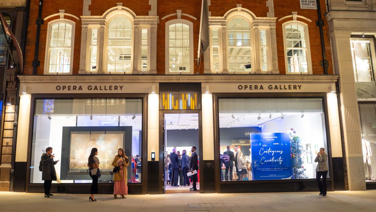 Opera Gallery on New Bond Street at night during the L'Atelier Five launch, with guests inside and on the pavement