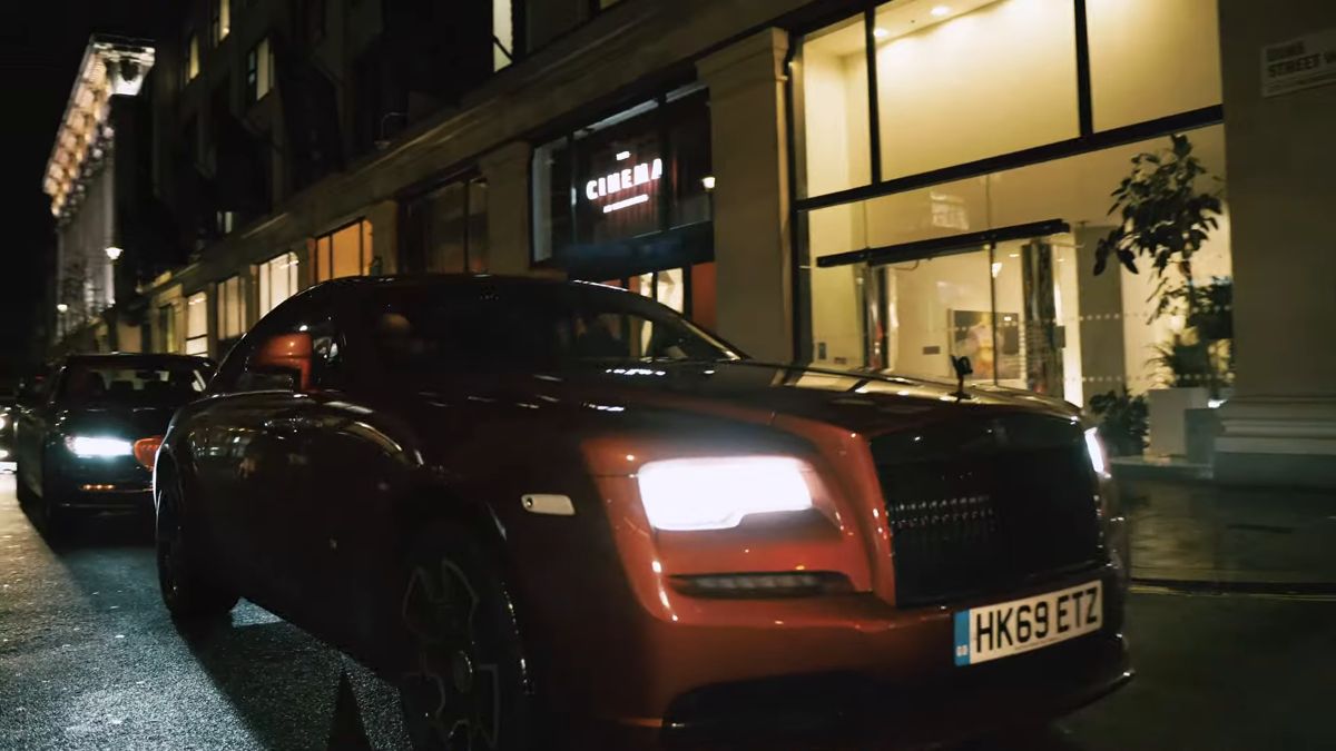 Rolls-Royce with headlights on at night outside the Boutique Baller London Fashion Week closing party
