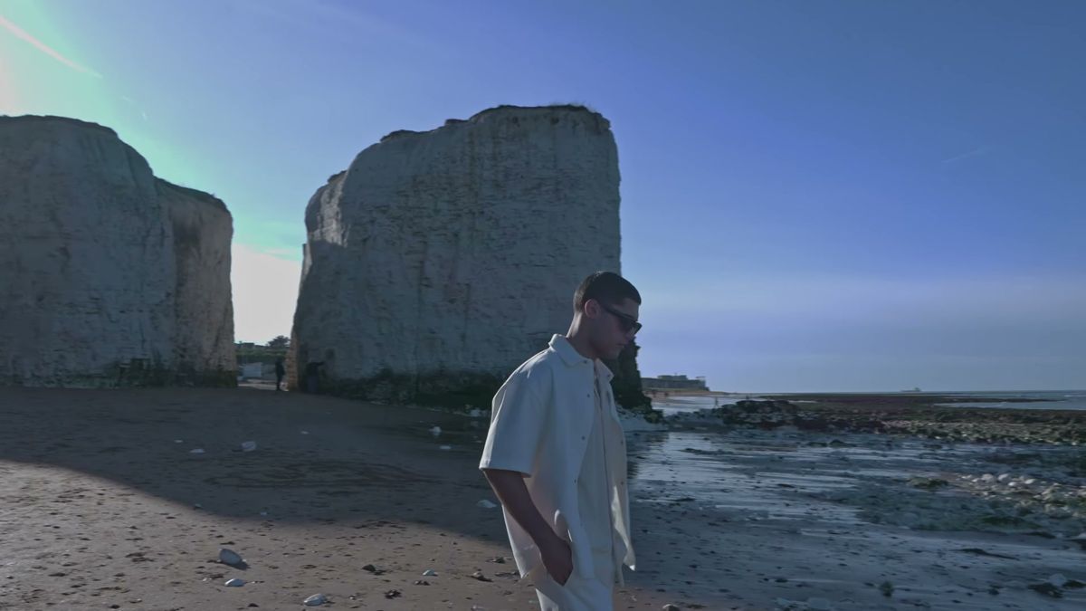 Vincent from Nevs Model Agency walking between chalk stacks on the Kent coast