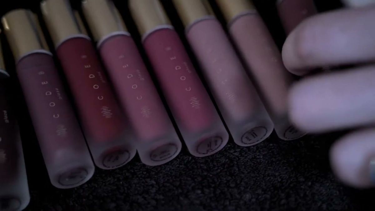Row of lip glosses held backstage at London Fashion Week