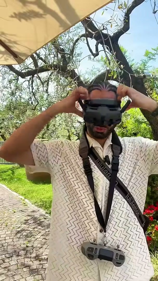 Joshua Swain putting on DJI goggles before an FPV flight at a wedding in Verona