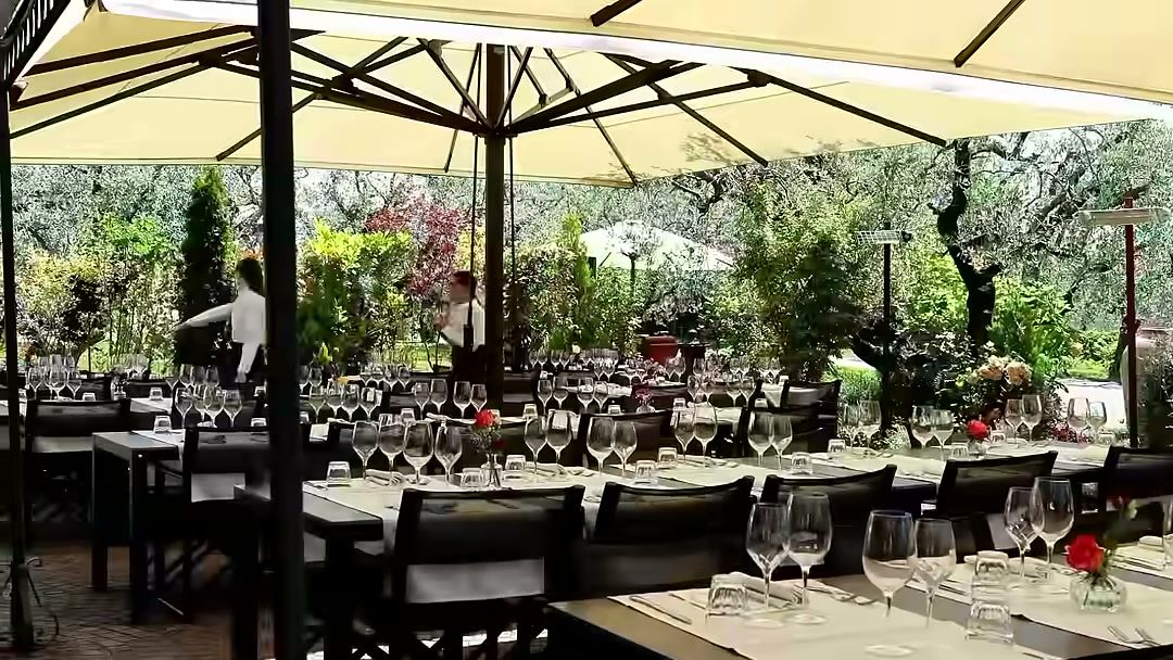 FPV pass over wedding reception tables set under umbrellas