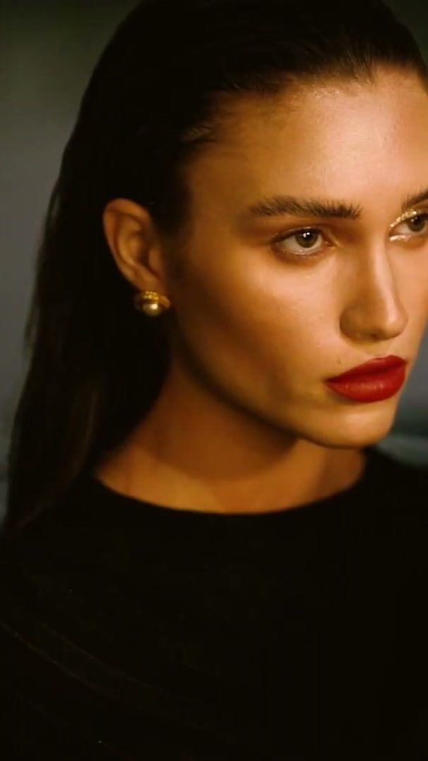 Sleek slicked-back hair and red lip by a pool at dusk, Dubai beauty shoot