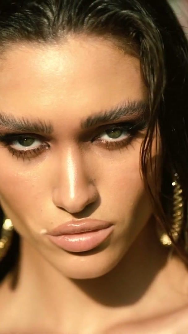 Wet-look hair and gold hoops on a model in a Dubai beauty shoot
