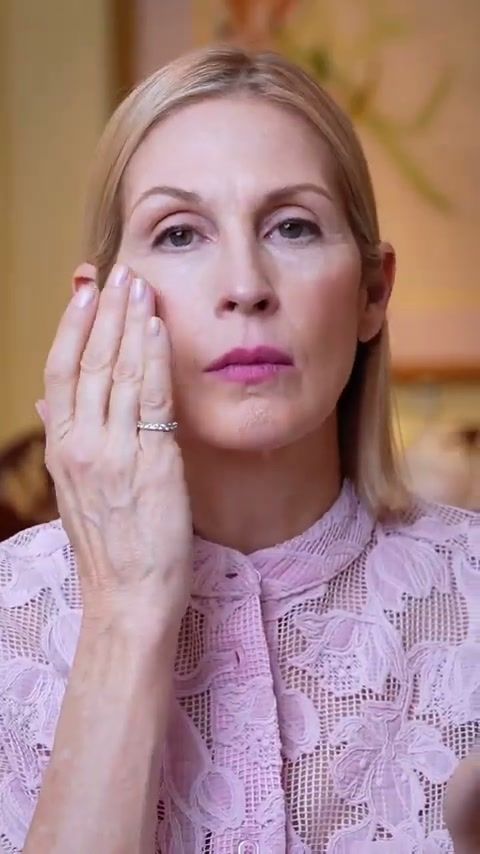 Kelly Rutherford applying make-up with her fingers in a pink lace blouse, Code8 campaign behind the scenes
