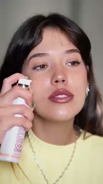 Young woman spraying a Seacra face mist close to camera in a vertical phone-style video