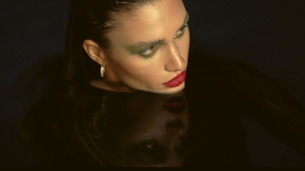 Jewellery editorial in Dubai, wet hair and gold earrings in low light