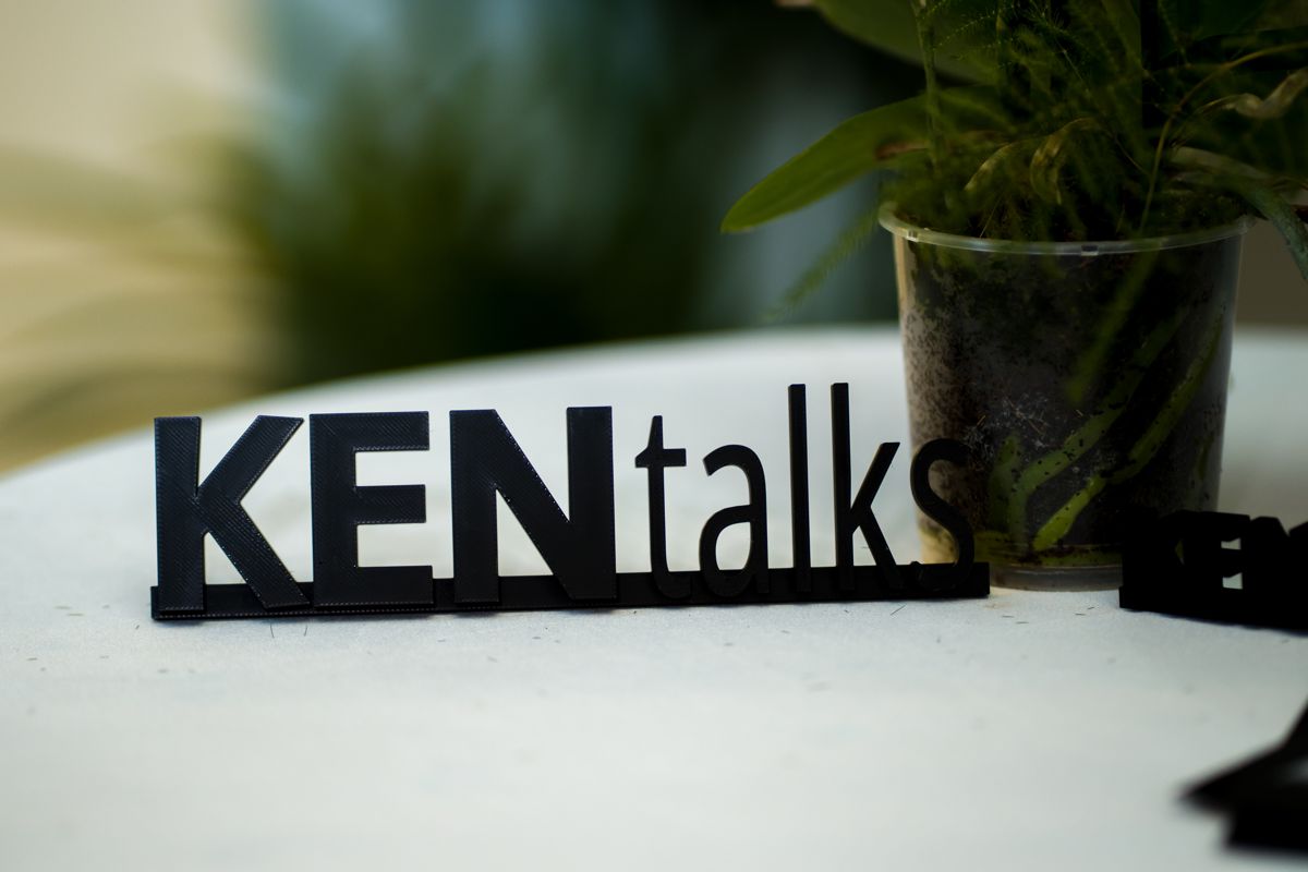 KEN Talks sign on a white table, event branding detail