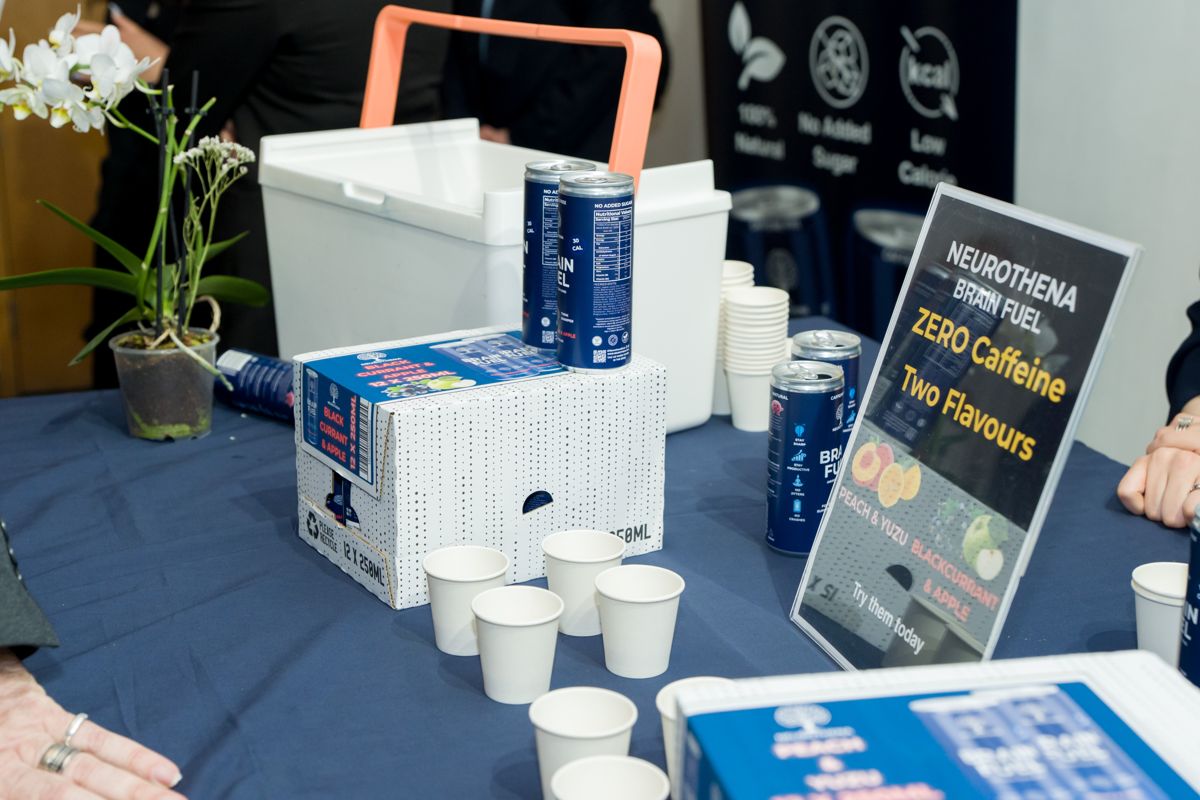 Sponsor drinks stand with cans, cups and signage in the KEN Talks foyer