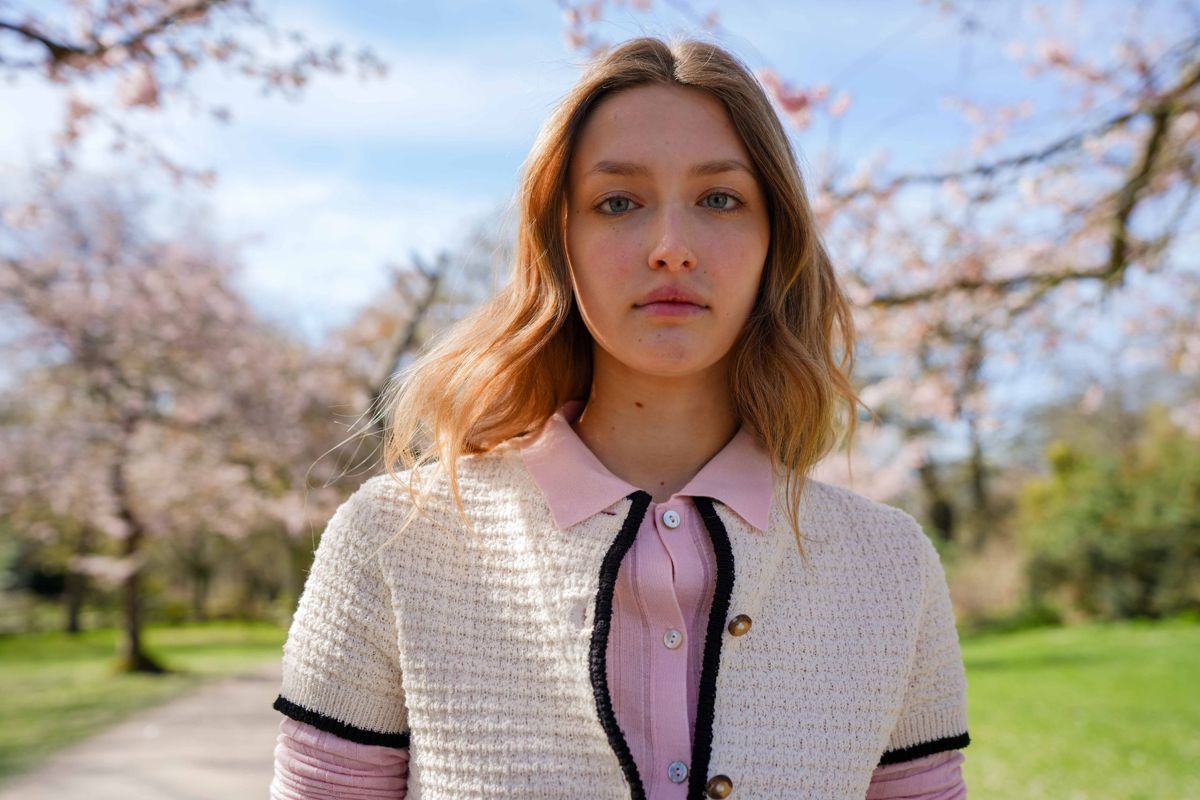 Backlit portrait among blossom trees in Richmond, London