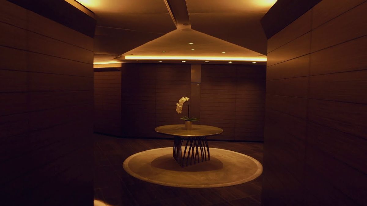 Warm lit corridor with an orchid on a round table, Armani Hotel Dubai