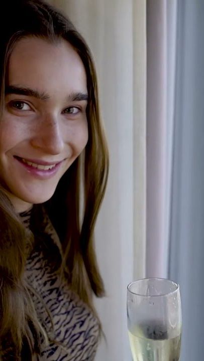 Model by the window with a glass of champagne in a hotel room, Catalonia Barcelona Plaza ad