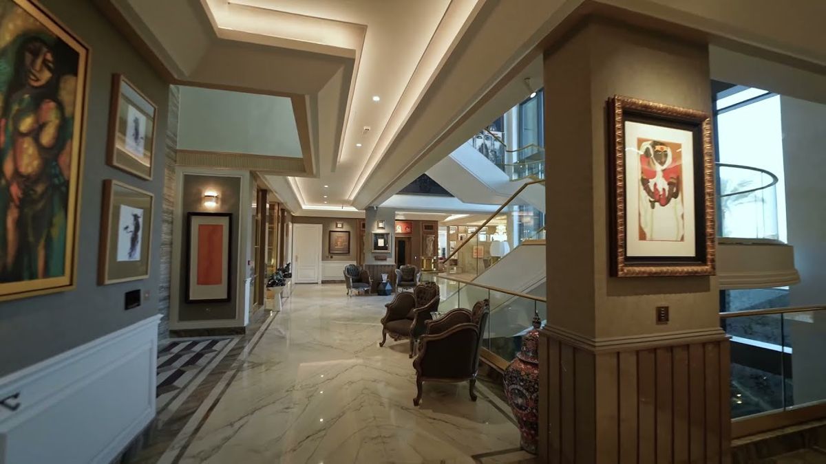Wide hallway with marble floors and framed art in a Dubai luxury property