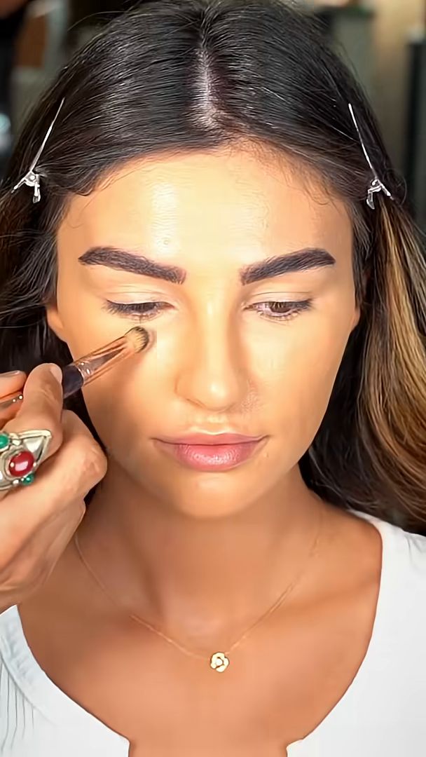 Concealer brushed under the eye during a Charlotte Tilbury campaign shoot