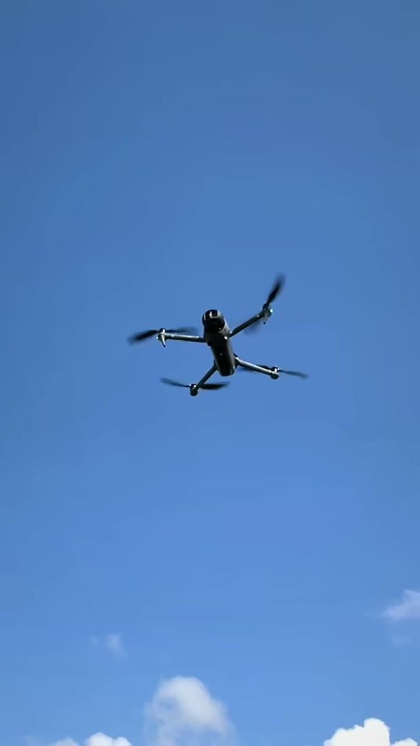 DJI Mavic 4 Pro flying against a clear blue sky