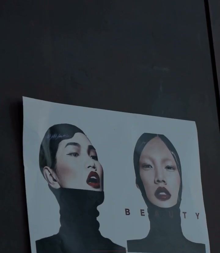 Reference print of two red-lip portraits taped to the wall on a beauty shoot