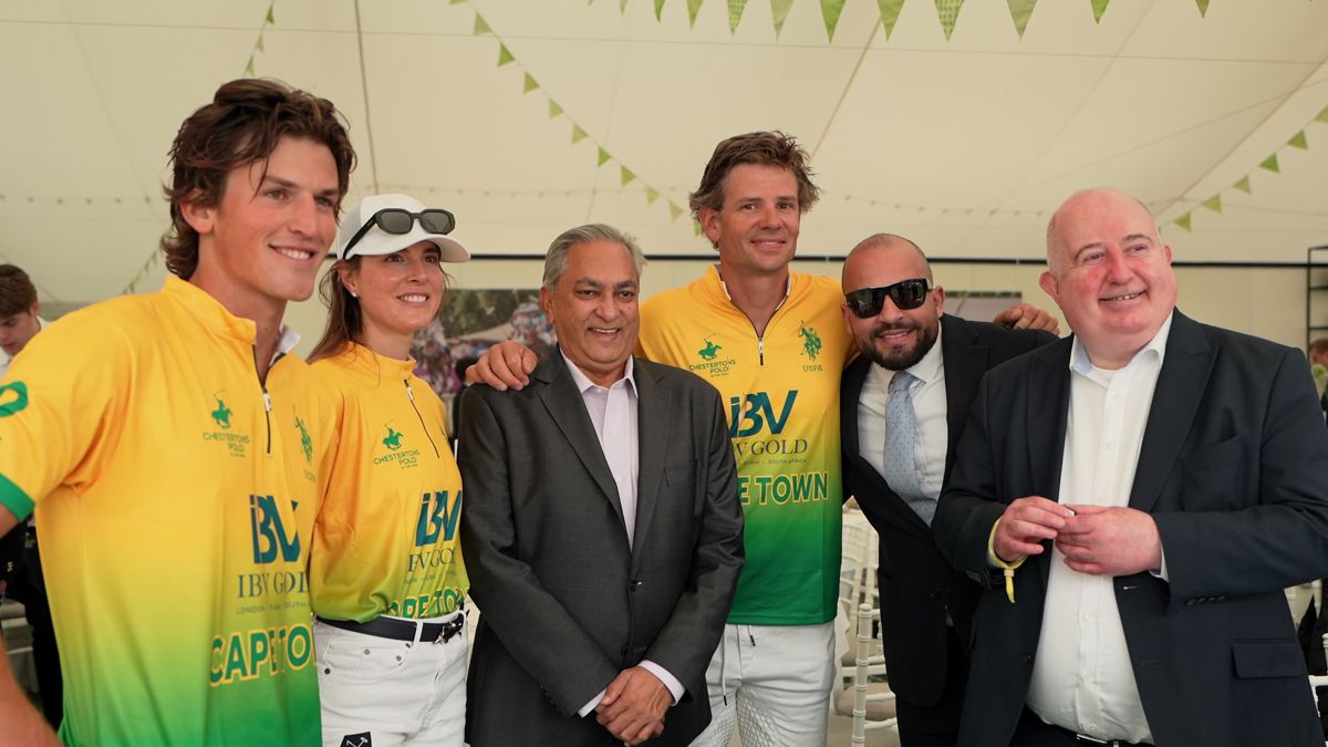 IBV Gold Team Cape Town players in yellow and green shirts with guests in the hospitality marquee