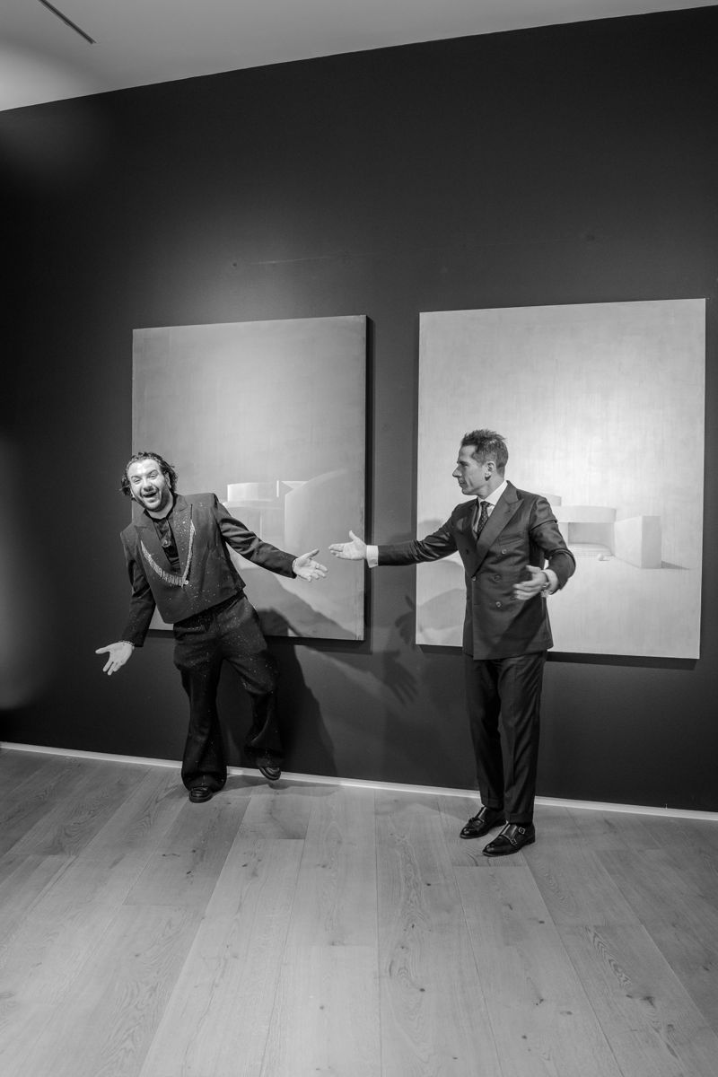 Black and white moment in front of paintings