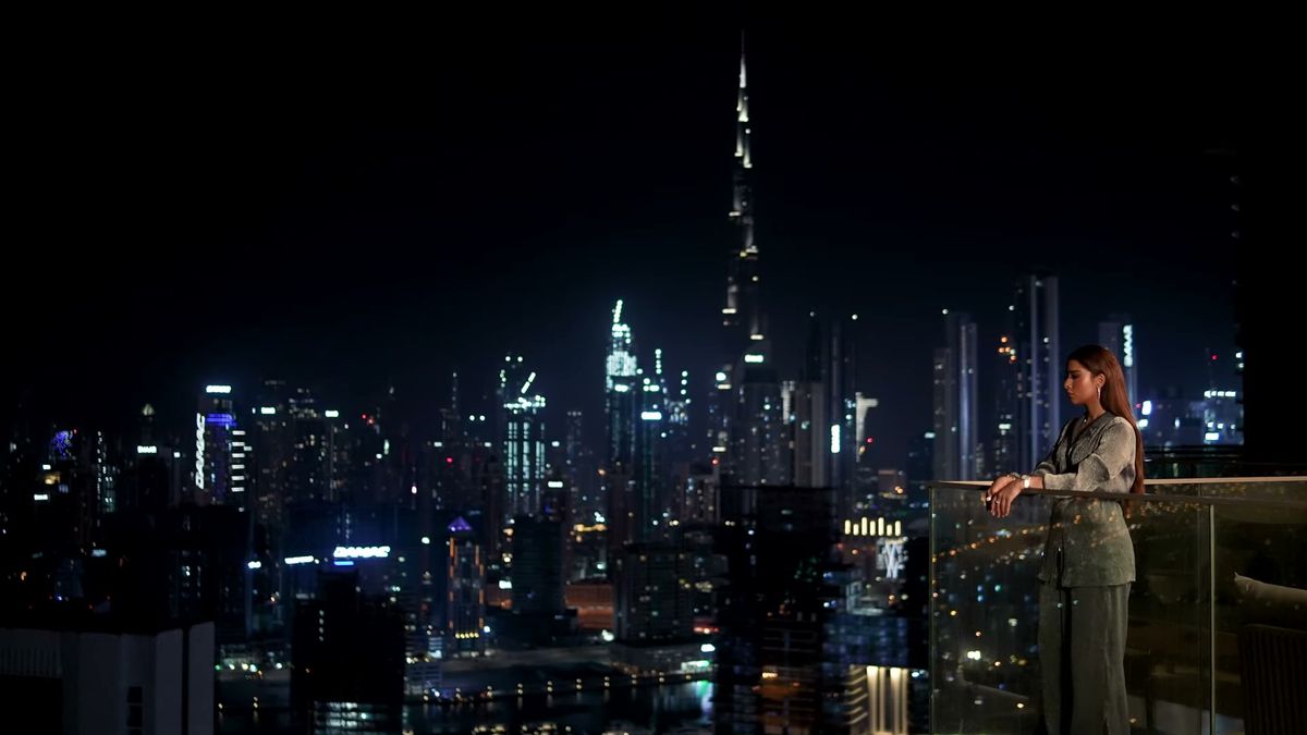 Balqees Fathi on a balcony above the Dubai skyline at night, behind the scenes of Piaget x Vogue Arabia