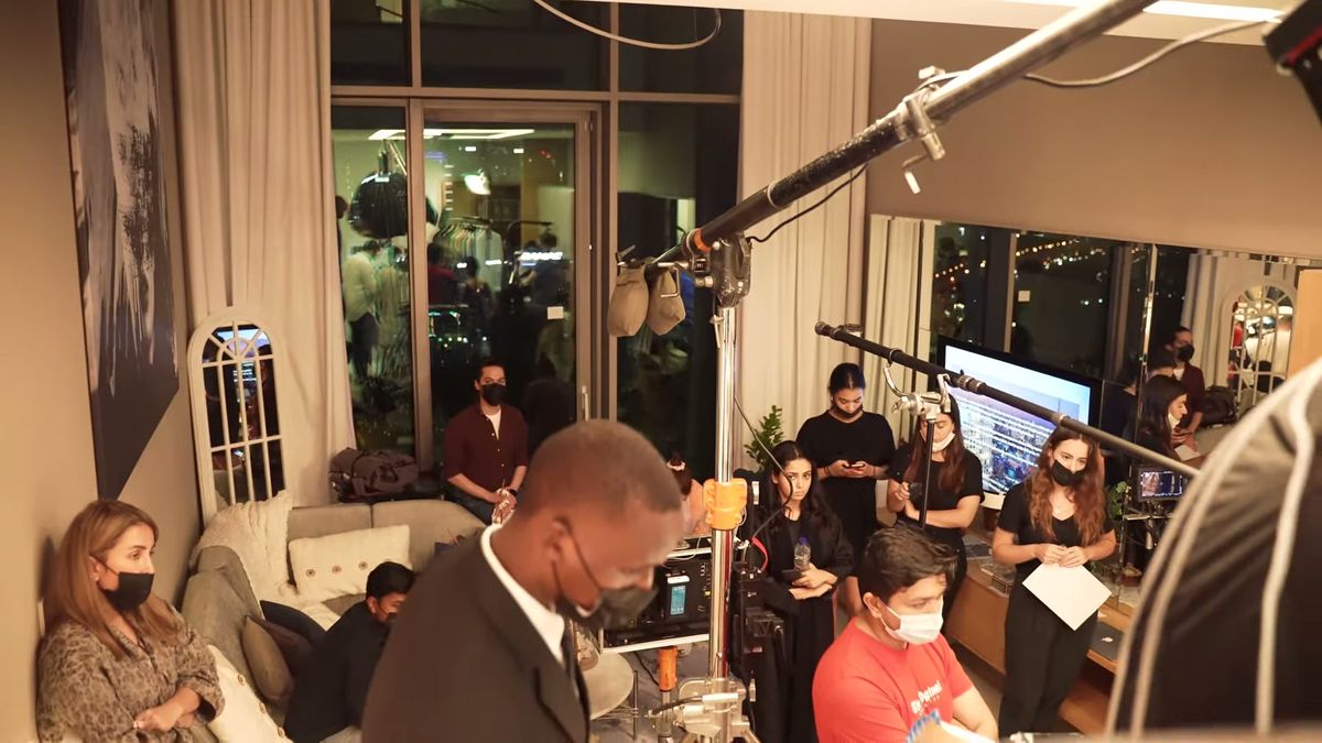 Crew, lighting stands and monitors inside a hotel suite on the Piaget x Vogue Arabia shoot in Dubai