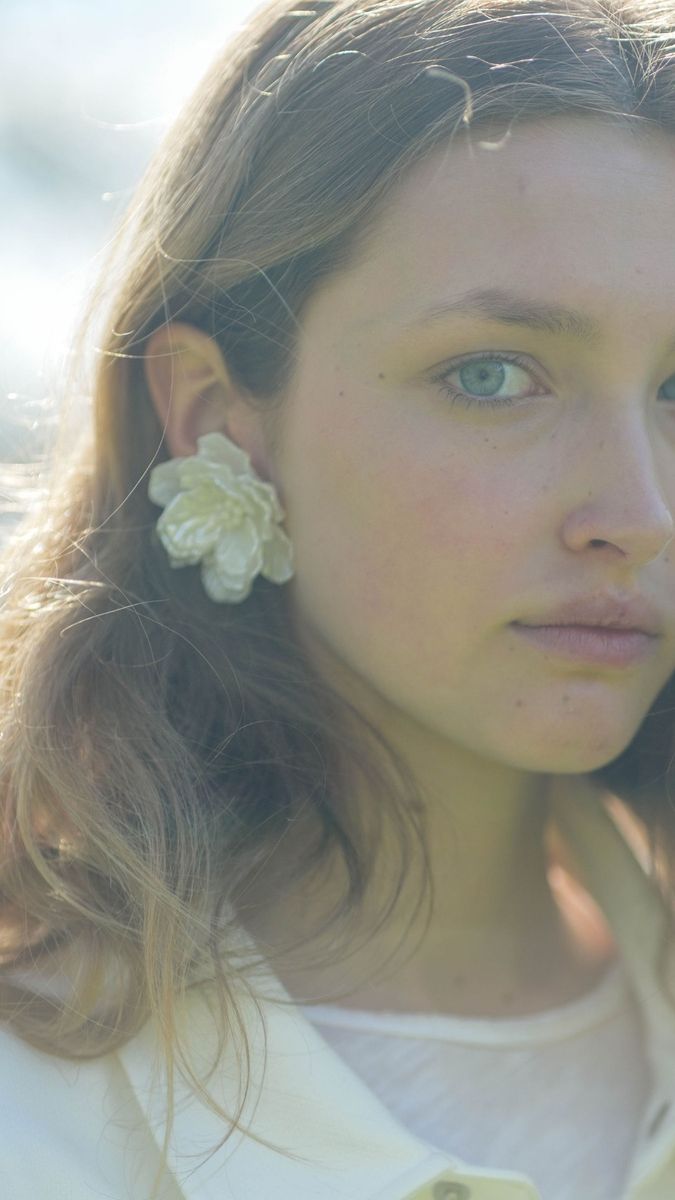 Backlit close portrait of Alice wearing a white flower earring, vertical frame, Richmond test shoot