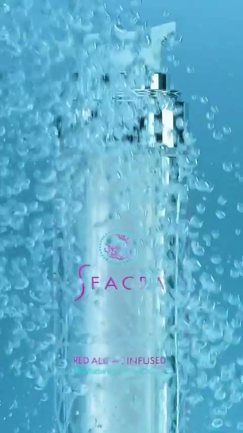Seacra Red Algae Infused bottle surrounded by bubbles in blue water